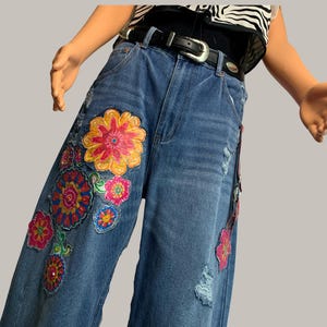 Upcycled Distressed Barrel Jean with Floral Design and Hardware.