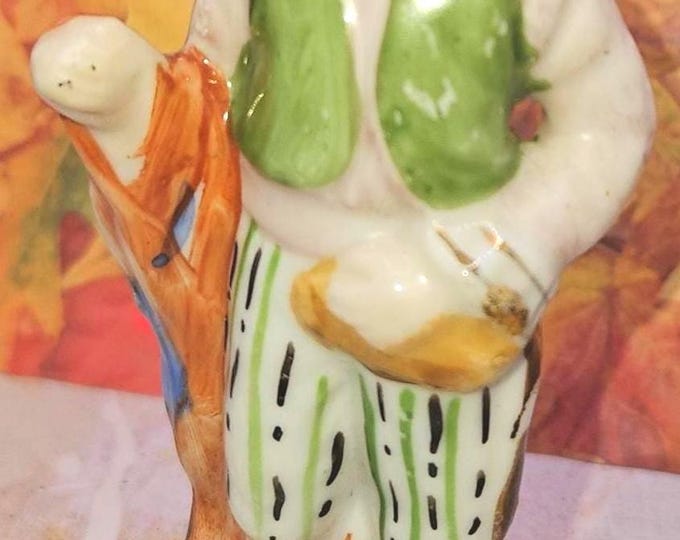 Vintage Occupied Japan Colonial Man standing holding a Red blanket draped over his arm D7/34