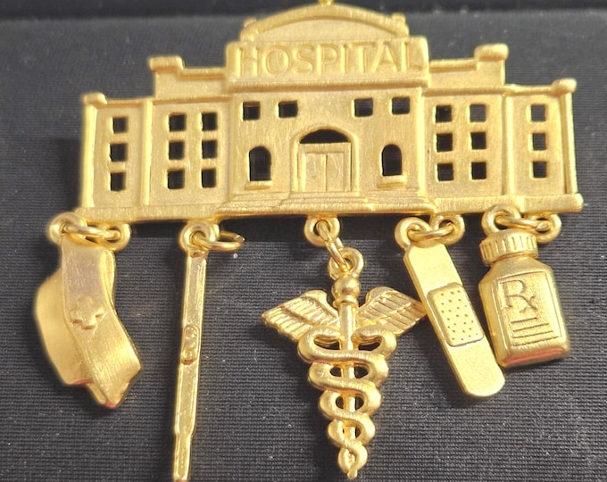 Vintage gold-tone J.J. hospital/caregiver brooch from the 1980s, signed. (Box)