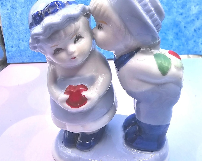 Young boy kissing the cheek of a girl A10/23