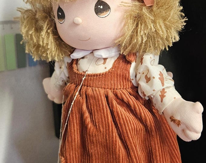 1988 Precious Moments "Autumn" Musical Doll (PM3-9). It's a great piece from the Four Seasons Musical Collection