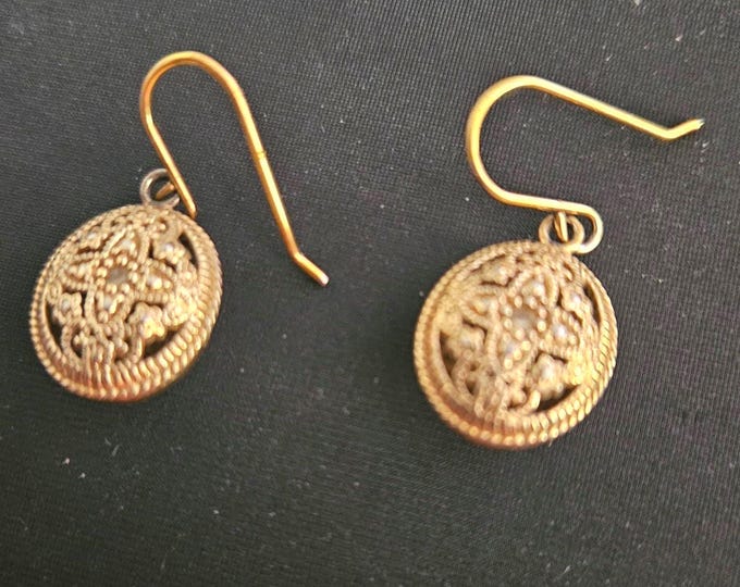 Vintage gold drop earrings featuring a beautiful cross with a diamond in the center. (Closet)