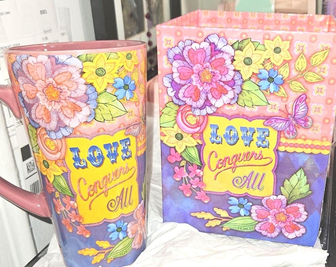 New 16 oz stoneware mug featuring the phrase “Love Conquers All.” 16oz Stoneware mug “Love Conquers All”B2/5