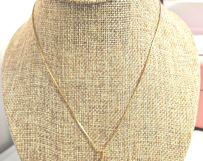 Vintage gold-tone necklace featuring a heart-shaped crystal pendant on a chain.