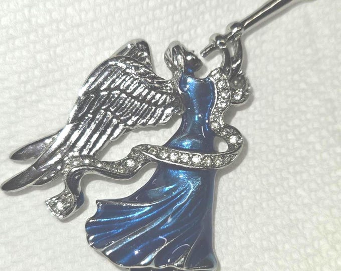 Vintage silver-tone brooch featuring a blue enamel herald angel horn adorned with rhinestones. (Shelf)