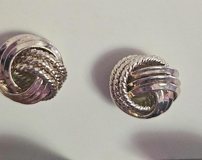 Vintage silver-tone earrings from Germany featuring a gold wash, with a smooth and textured knot design.