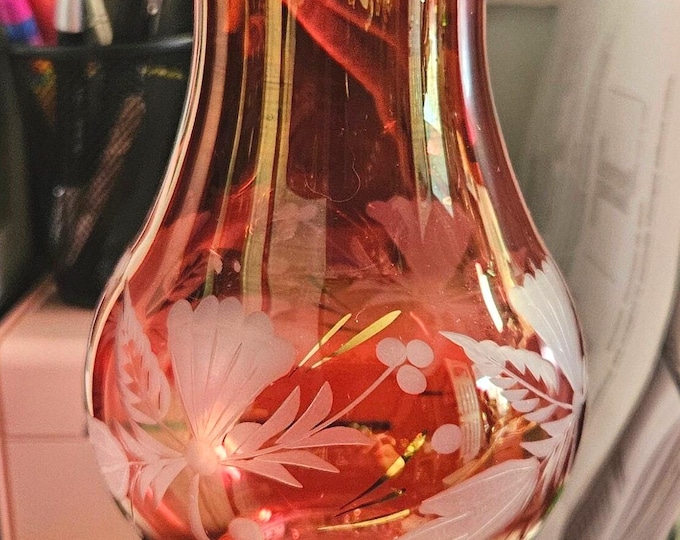 Vintage cranberry vase featuring 24k gold trim and an etched floral design, rated C9/10.
