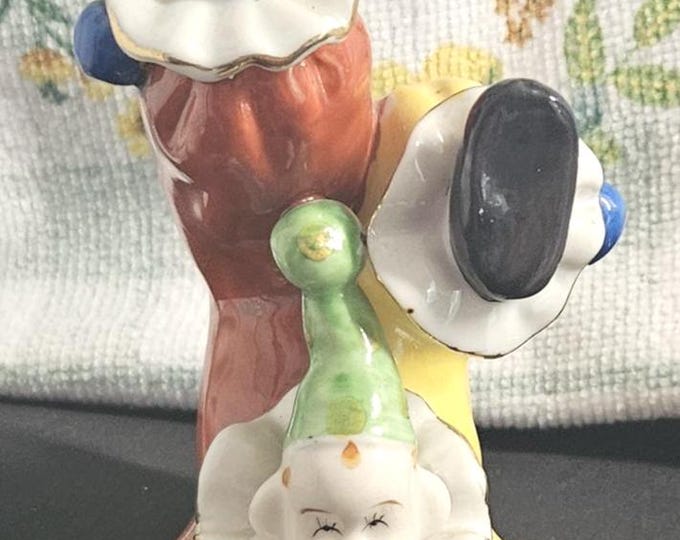 Vintage Porcelain Figurine of a Tumbling Upside-Down Clown with Gold Trim.