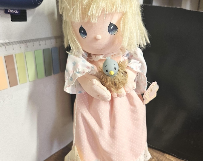 1988 Precious Moments "Spring" Musical Doll (PM3-9). It's a great piece from the Four Seasons Musical Collection