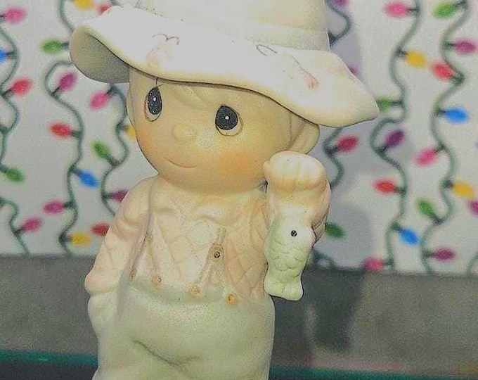 The 1988 Precious Moments figurine titled "My Love Will Never Let You Go," B2/6.