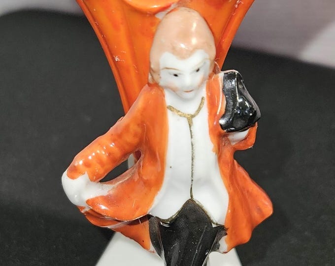 Discover this exquisite vintage vase from Occupied Japan, showcasing a charming young man dressed in a stylish dinner coat and hat.B7/8
