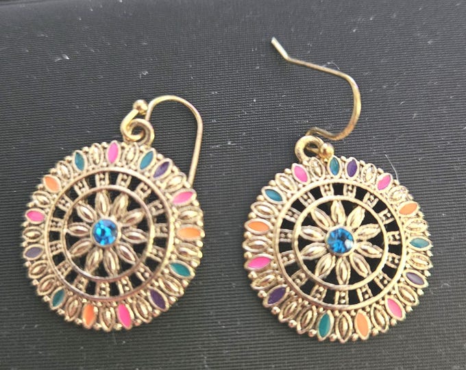 Set of flower burst earrings featuring a blue center stone, surrounded by rainbow-colored edges. Gold setting enhances colors