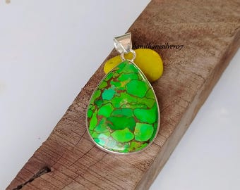 May include: A silver pendant with a green and brown turquoise stone in a teardrop shape.