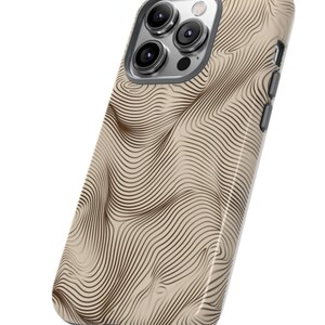 May include: A beige phone case with a brown wavy line pattern. The case has a camera lens cutout and a cutout for the phone's buttons.