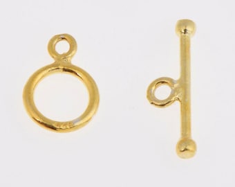 May include: Gold-toned metal toggle clasp with a round ring and a straight bar. The clasp is used for jewelry making.