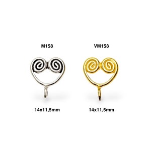 May include: Two metal heart-shaped charms with a swirl design. The charm on the left is silver and the charm on the right is gold. Both charms are 14x11.5mm.