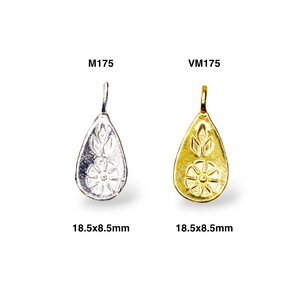 May include: Two silver and gold pendants with a floral design. The pendants are shaped like teardrops and measure 18.5 x 8.5 mm. The silver pendant is labeled M1175 and the gold pendant is labeled VM175.