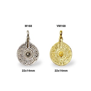 May include: Two round pendants, one silver and one gold, with intricate designs and a small bead in the center. Both pendants are 22x14mm.