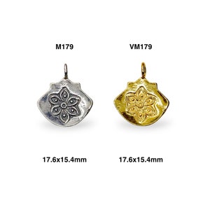 May include: Two silver and gold pendants with a flower design. The pendants are 17.6x15.4 mm in size. The silver pendant is labeled M179 and the gold pendant is labeled VM179.