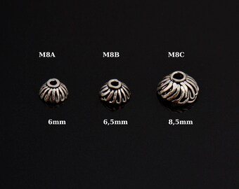 May include: Three silver metal bead caps in different sizes. The caps are 6mm, 6.5mm, and 8.5mm in diameter.