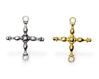 May include: Two metal cross charms, one silver and one gold. Each charm has a loop at the top and four arms with rounded ends.