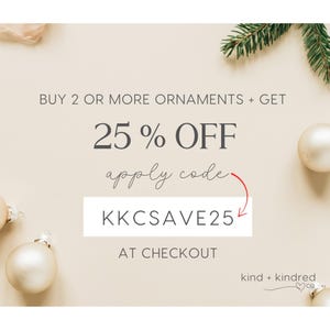 May include: A beige promotional graphic featuring dark gray text that reads BUY 2 OR MORE ORNAMENTS + GET 25 % OFF apply code KKCSAVE25 AT CHECKOUT. The design includes a red arrow pointing to the code, cream-colored ornaments, and pine needles.