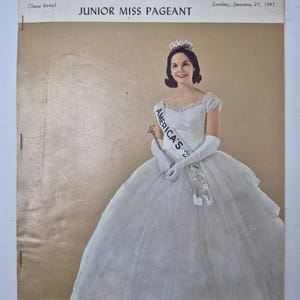 May include: Vintage program cover for Missouri's Junior Miss Pageant, featuring a woman in a white gown, tiara, and sash that reads "America's Junior Miss". The program is dated Sunday, January 27, 1963, and includes the Chase Hotel.