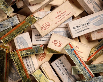 A unique collection of vintage medical tools curiosity syringes, different sizes, some original boxes.