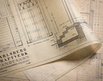 May include: A close-up of a blueprint for a staircase and tower, with the text "Carlsberg Raftverk Vandtaarn" and "Hovedtrappen & Taarnet" visible. The blueprint is drawn on aged, yellowed paper.