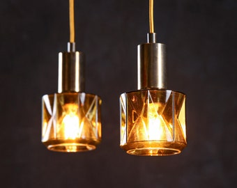 A pair of vintage glass and brass pendant lamps by Carl Fagerlund for Orrefors Sweden MCM Scandinavian lighting design