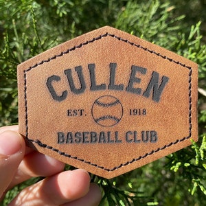 May include: A brown leather patch with black stitching and the text "CULLEN EST. 1918 BASEBALL CLUB" with a baseball graphic.