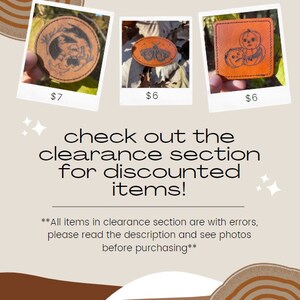 May include: Three leather coasters with engraved designs. The first coaster features a black and white illustration of a moth, the second coaster features a black and white illustration of a pumpkin, and the third coaster features a black and white illustration of a bird. The coasters are all priced at $6.