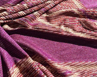Italian stretch viscose lurex jersey, asymmetric fabric patterns in red-violet and lurex in gold tones