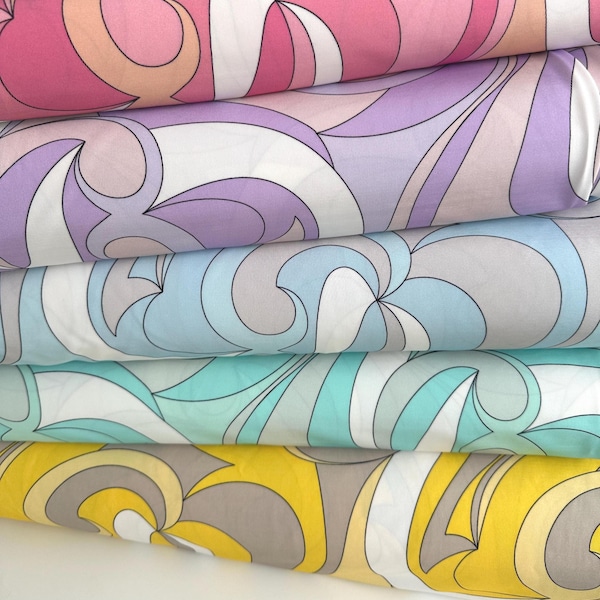 May include: A stack of fabric rolls with a retro, swirling pattern. The fabric features a variety of colors, including pink, purple, blue, teal, yellow, and gray, with white accents. The design is reminiscent of the 1960s and 1970s.