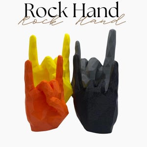 May include: Three hand sculptures in the rock and roll gesture. One is orange, one is yellow, and the third is black. The text "Rock Hand" is at the top of the image.