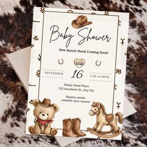 May include: Baby shower invitation with a cowboy theme. The invitation features a teddy bear, cowboy boots, and a rocking horse. The text reads "Baby Shower" and "New Ranch Hand Coming Soon!" with the date and time.