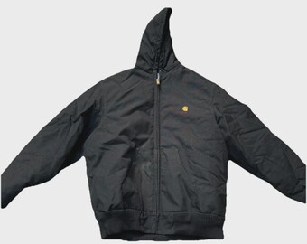 May include: Black hooded jacket with a zipper closure and a small yellow logo on the chest. The jacket has a ribbed hem and cuffs. The hood is attached and the jacket appears to be made of a durable material.