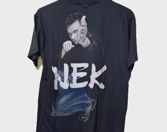 May include: Black t-shirt featuring a graphic of a man in a crouched pose with the word "NEK" in white block letters. The image is a vintage design, likely from the 1990s or early 2000s.