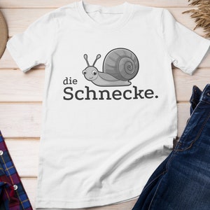 May include: White t-shirt with a gray cartoon snail and the text "die Schnecke."