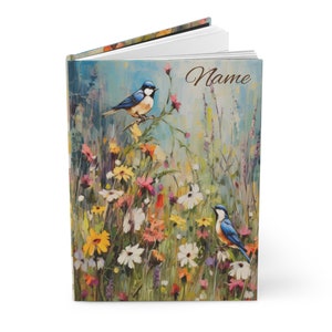 May include: A bluebird perched on a branch in a field of wildflowers. The background is a soft blue and green with a blurred effect. The book cover has the word "Name" printed on it.