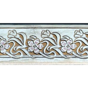 May include: A white wooden plaque with a carved design of stylized flowers and leaves. The flowers are brown with pink centers and the leaves are white.