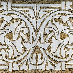 May include: A white and gold decorative tile with an intricate floral pattern. The design features stylized leaves and vines, creating a symmetrical and elegant motif.