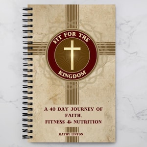 May include: A brown spiral bound journal with a gold and brown design. The cover features a red circle with a gold cross and the text "Fit for the Kingdom". The text "A 40 Day Journey of Faith, Fitness & Nutrition" is printed below the circle. The author's name, "Kathy Linton", is printed at the bottom of the cover.