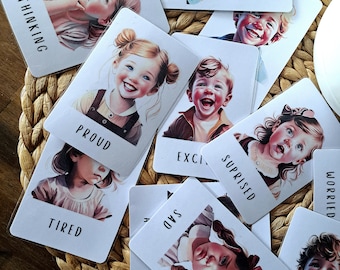 May include: A set of ten colorful cards with illustrations of children and words describing emotions. The words on the cards are "Thinking", "Proud", "Excited", "Surprised", "Sad", "Tired", "Worried", "Happy", "Angry", and "Scared".