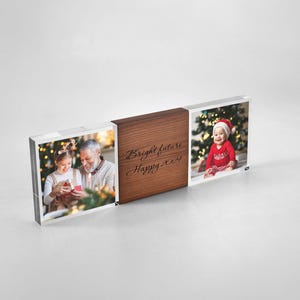 May include: A rectangular desk display featuring two clear acrylic photo blocks flanking a central wooden block. The left block shows a child and adult, the right shows a baby in a red outfit, and the center wood piece is engraved with "Bright future Happy 2024".