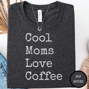 May include: A set of three ceramic mugs with a speckled, matte finish. The mugs are in shades of cream, light gray, and dark gray. Each mug has a simple, minimalist design and a rounded handle. Perfect for coffee or tea.