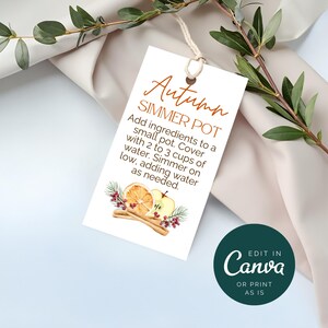 May include: A white tag with the text "Autumn SIMMER POT" and instructions for use. The tag features watercolor illustrations of fruit and cinnamon sticks. A green circle with "Edit in Canva" is in the bottom right.