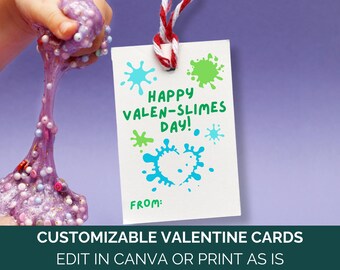 May include: A white card with a blue and green paint splatter design. The card says "Happy Valen-Slimes Day!" and has a space for a name at the bottom. The card is tied with a red and white string.