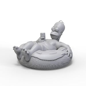 May include: A gray 3D printed figurine of a cartoon character relaxing in a gray inflatable ring. The character is holding a can in one hand and has a relaxed expression on its face.