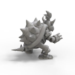May include: A grey 3D printed figurine of a spiky, turtle-like character with a crown and a spiked tail. The character is in a crouching pose with its arms outstretched.